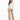A woman stands confidently in a fitted cream jacket paired with beige wide-leg trousers and black heels.