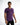 A model wearing a fitted purple t-shirt with motivational text printed across the chest, paired with black jeans.