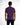 A man stands with his back to the camera, wearing a fitted purple short-sleeve shirt and black jeans.