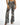 Marlee high-waisted wide-leg flare pants featuring a bold black and white geometric tribal bohemian print.