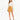 A model wearing a long-sleeve cream top paired with a mustard-colored mini skirt and black strappy heels.
