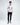 A young man stands confidently in a white long-sleeve shirt with colorful graphics and text, paired with blac...