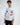 A model wearing a white long-sleeve shirt with colorful graphics and playful text designs.