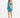 A model poses in a vibrant blue and green one-shoulder dress with a cutout and ruched detailing.