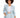 Light blue blazer with a belted waist, paired with matching shorts and a white crop top, worn by a model with curly h...