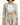 Light green blazer with a tied waist, paired with a white crop top and matching trousers.