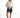 Model in high-waisted Maxine grey washed denim shorts with a white tie-front shirt and sneakers.