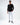 Model wearing Elliott white distressed denim jeans and black long sleeve shirt for urban streetwear style.