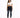 A woman stands confidently in a cropped white top and dark skinny jeans with distressed details, paired with white sn...