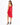 A woman poses in a form-fitting red dress with one shoulder exposed and a thigh-high slit, paired with black heels.