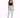 A woman stands confidently in light-wash ripped jeans paired with a black crop top and strappy heels.