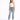 A woman poses in distressed light blue jeans with a white one-shoulder top and black high-heeled sandals.