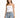 A woman stands confidently in light blue distressed jeans with a drawstring waist and a fitted white top.
