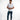 Man in white Mind Power graphic streetwear t-shirt and blue jeans against a white background.