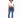 A model poses in a cropped white top with a drawstring and blue skinny jeans, paired with white sneakers.