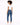 A model with curly hair wears a fitted white top and blue skinny jeans, paired with white sneakers, facing away.