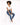 A model with curly hair sits on a white pedestal, wearing a cropped white top and blue skinny jeans.