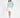 Model wearing a teal More and Less embroidered knit sweatshirt with white mini skirt and nude heels.