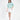 Model wearing a teal More and Less embroidered knit sweatshirt with white mini skirt and nude heels.