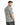 A man with a stylish haircut wears a short-sleeve shirt featuring a black and white grid pattern.