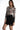Model in Elora long-sleeve nude bodysuit with black damask pattern and black lace-trim skirt.