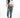 Model wearing the white Stevie long-sleeve ribbed crop top with high-waisted blue jeans and grey fur slides.