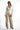 Model wearing the Eden white one-button blazer with a tailored fit, paired with beige wide-leg trousers and black heels.