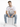 Model sitting wearing blue distressed jeans with white sneakers