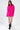 Model wearing the Brooke hot pink oversized knit sweater with trendy shoulder cut-outs and a mock neck.