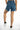 Rear view of Sunny Blue high-waisted denim shorts with a double waistband, back pockets, and frayed raw hem fringe.