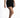Model wearing Lillie high-waisted denim shorts in black wash, styled with a tie-dye top and black sneakers.