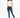 Model in Verona Essential Tee, a white pleated sleeveless crop top, with blue skinny jeans and white sneakers.