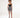Model in Nika black sleeveless crop top with silver chain straps and a patterned mini skirt.
