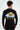 Back view of a black long-sleeve street shirt featuring a colorful sun and cloud graphic on an oversized urban fit.