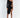 Model in Valeria Black Mini Dress featuring a one-shoulder design, side cut-outs, and asymmetrical high-slit hem.