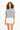 Model wearing a light blue Orlando Ribbed Crop Top with collegiate graphic and white high-waisted shorts.