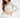 Model wearing the Lexie Top, a white ribbed one-shoulder long sleeve crop top paired with white sweatpants.