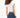 Back view of the Luna white ribbed cropped tank top and blue skinny jeans, highlighting the athletic body-hugging fit.