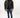 Man in Brooks black puffer coat with high collar, paired with distressed blue skinny jeans and black sneakers.