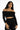 Model in Dulce black off-the-shoulder bodysuit with long sleeves and corset-style ribbing, streetwear aesthetic.