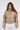 Thea Beige faux leather puffer coat for women with high neck and silver ring zipper pull worn by model.