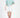 Model wearing the More and Less teal knit cropped sweatshirt and a white mini skirt against a white background.