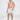 Model wearing Walker sailboat patterned swim trunks and white slides, showcasing a trendy men's summer beachwear look.