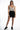 Harmoni Seamless Bodysuit in Carbon tie-dye with scoop neck, paired with high-waisted black denim shorts.