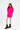 Model in vibrant hot pink Brooke Sweater featuring an oversized knit fit and trendy arm cut-outs with black combat boots.
