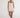 Model wearing the Scarlet Romper, a beige summer one-piece with crossover bodice and thin straps.