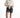 Model in high-waisted Maxine grey washed denim shorts with a white tie-front shirt and sneakers.
