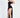 Model in Kennedy black glitter dress with high-low skirt, sweetheart neckline, and thin straps for a trendy evening look.