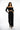 Model in Dulce black off-the-shoulder bodysuit with corset ribbing and matching wide-leg trousers streetwear.