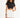 Model in carbon black cut out crop top and high-waisted white denim shorts, a streetwear aesthetic essential.
